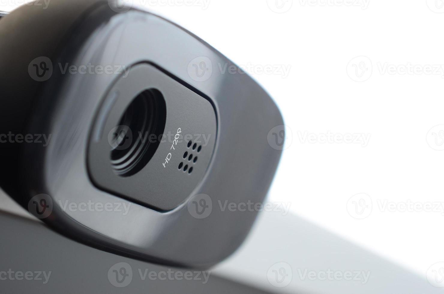 A modern web camera is installed on the body of a flat screen monitor. Device for video communication and recording of high quality video photo
