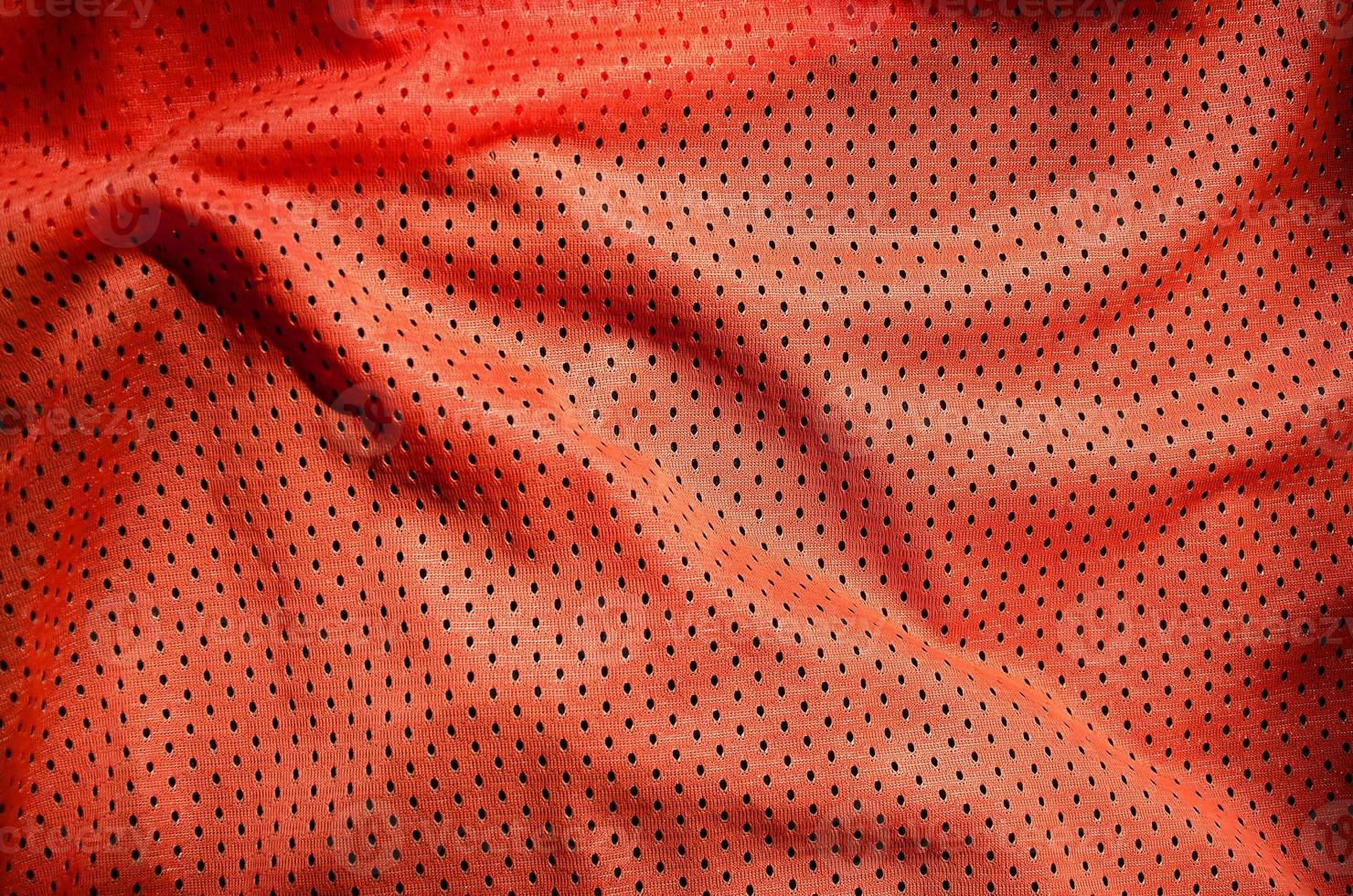 Close up of red polyester nylon sportswear shorts to created a textured background photo