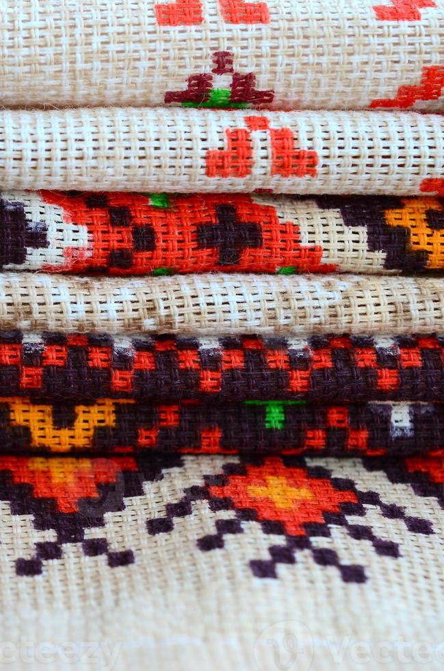 Stack of traditional Ukrainian folk art knitted embroidery patterns on textile fabric photo