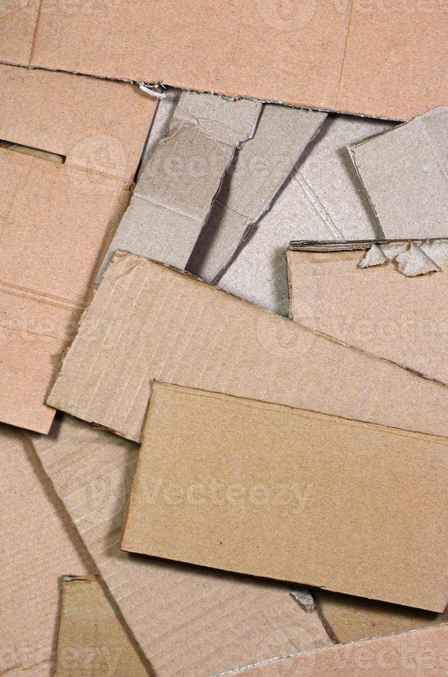 Background image with a lot of beige cardboard paper, which is used to make boxes for the transport of home appliances and postal parcels. Carton texture photo