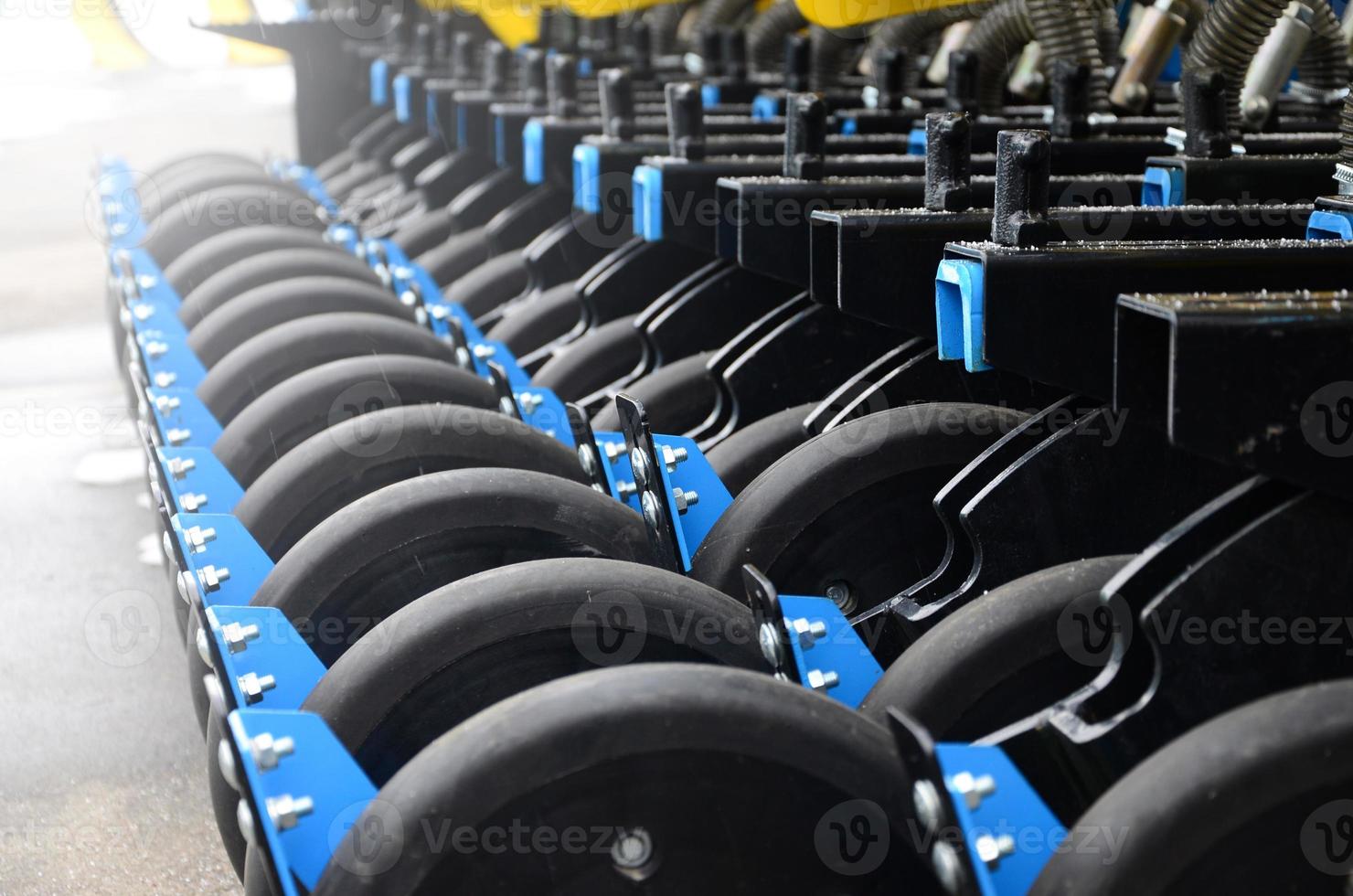 Row of wheels of the new industrial agricultural seeder close up photo