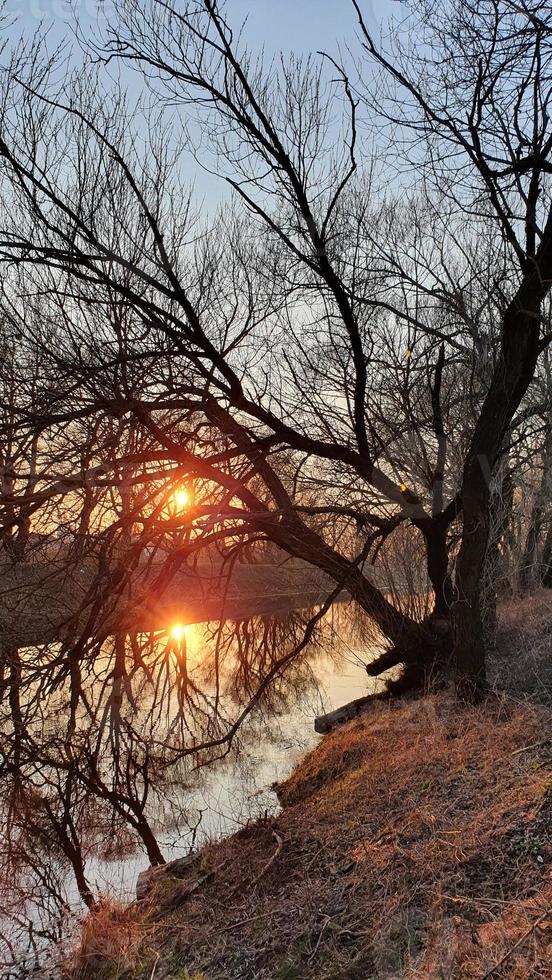 Art grunge landscape showing sunrise over the river on beautiful autumn day photo