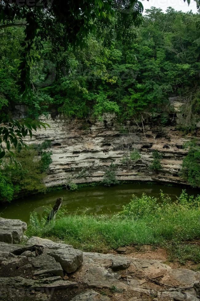 Cenote, Mexico. Lovely cenote in Yucatan Peninsulla with transparent waters and hanging roots. Chichen Itza, Central America. photo