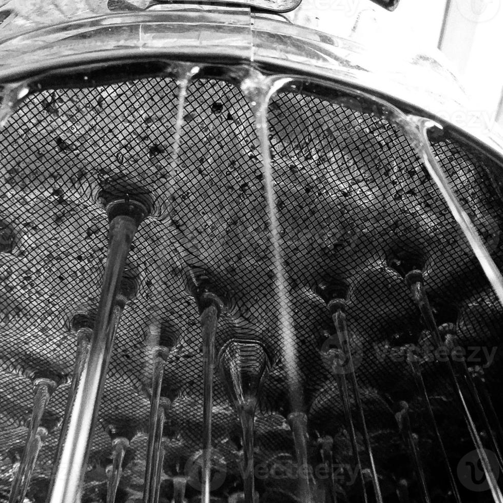 Drop of bee honey drip from hexagonal honeycombs photo