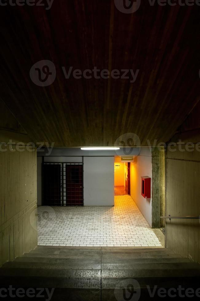 orange light that contrasts with the concrete modern concrete architecture cement building brutalist , stairs of an institution or school, photo