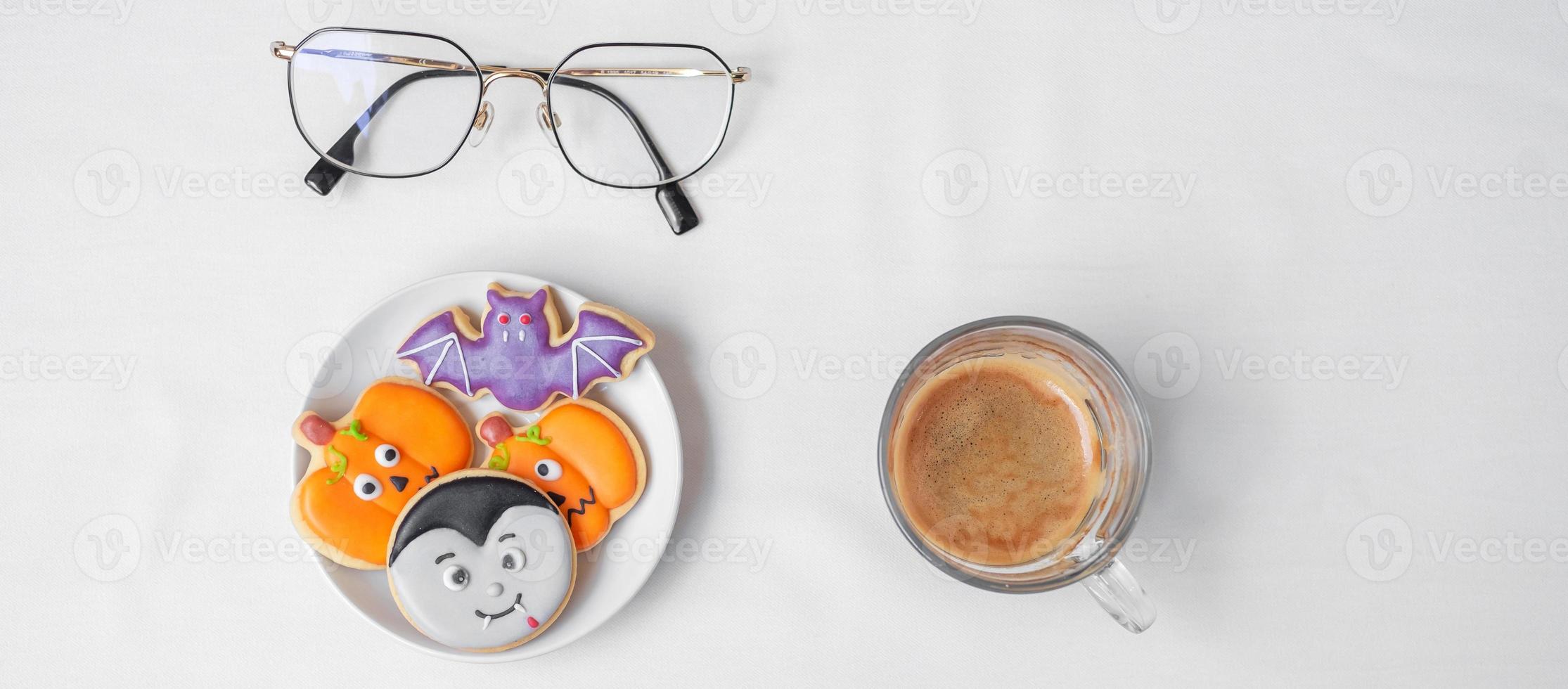 hot espresso coffee  or chocolate cup with funny Halloween Cookies. Happy Halloween day, Trick or Threat, Hello October, fall autumn, Traditional, party and holiday concept photo