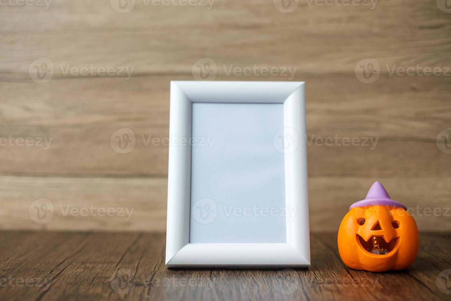 Orange pumpkin on table and frame with copy space for text. Happy Halloween day, Hello October, fall autumn season, Festive, party and holiday concept photo