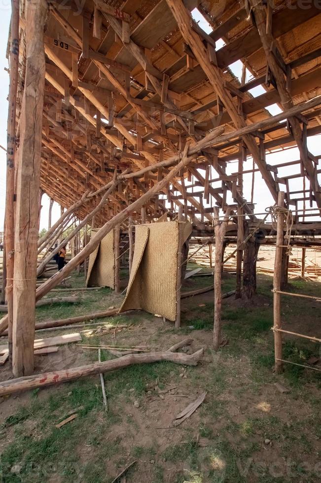 man making wooden roof, mason making roof formwork, with cap and hammer, mexico photo