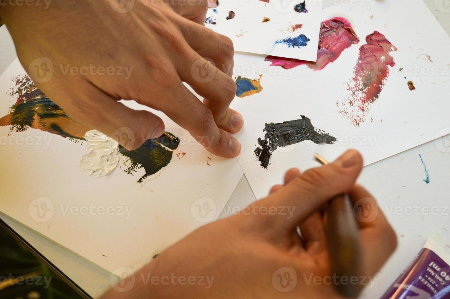 painting with spatula on blank canvases, with oil paints photo