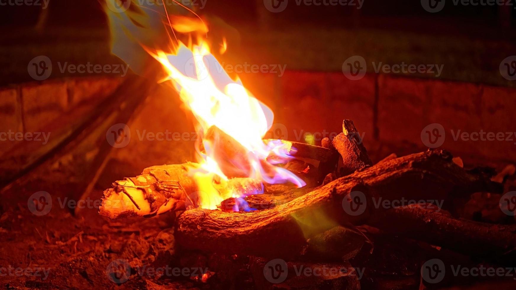 Flames Of Fire With Fly Sparks Isolated On Black Background. Abstract Flaming Background. photo