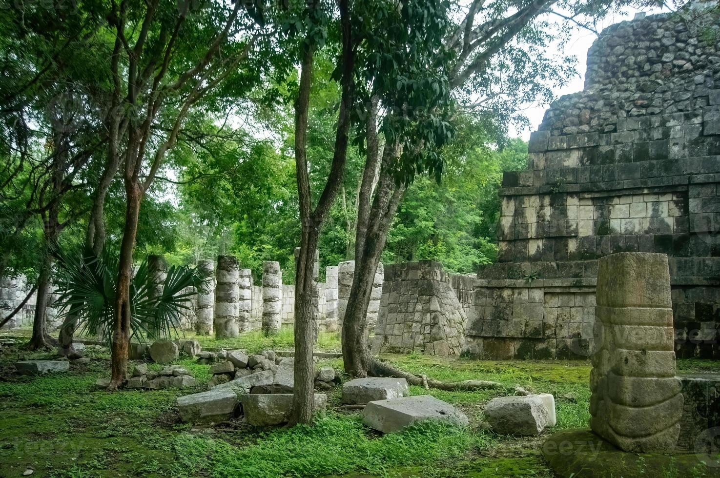 mayan pyramids in mexico, stone construction, surrounded by vegetation, deep jungle photo