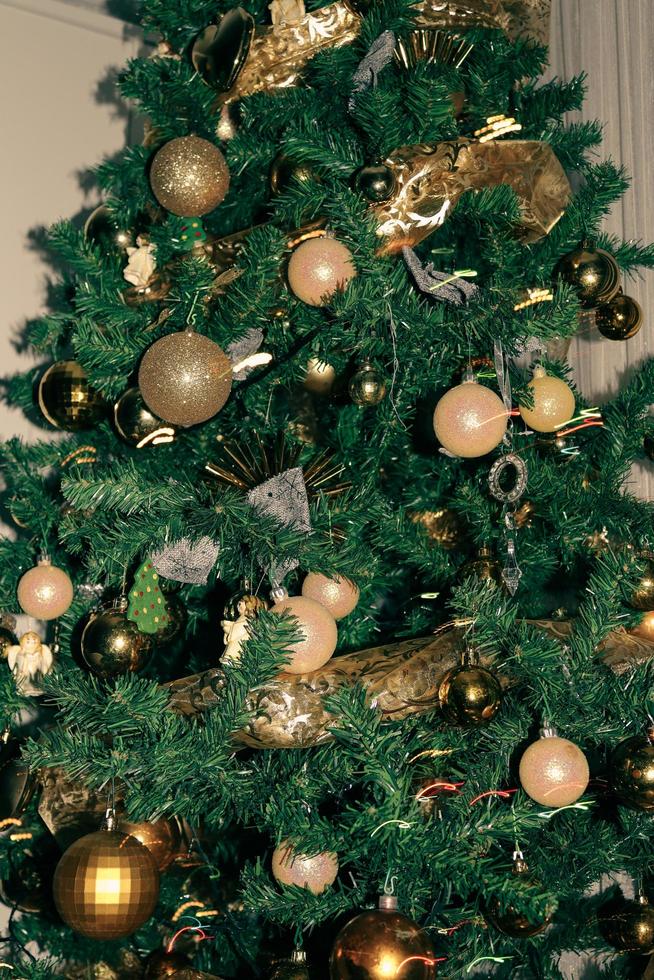 Christmas tree adorned with golden globes and angels photo