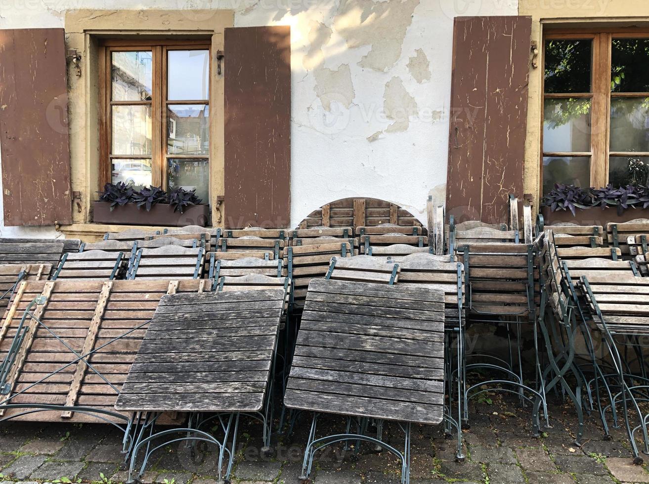 Closed restaurant with tables and chairs stacked against the wall photo