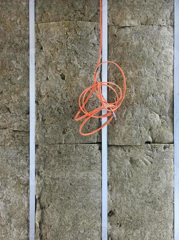 Detail of wall with open insulation at a construction site photo