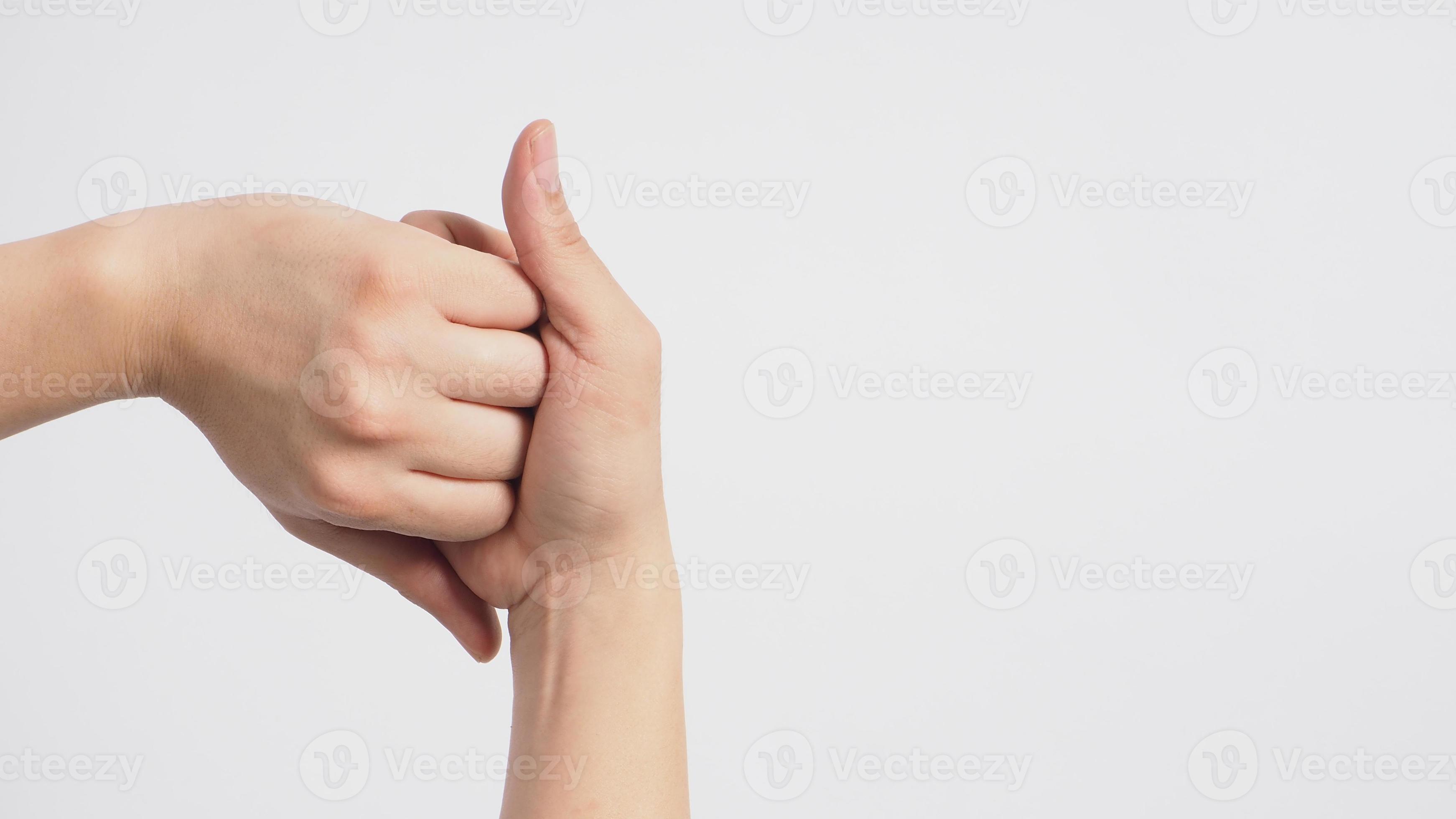 Male model is interlock fingers and rub midjoints on white background. 12395533 Stock Photo at
