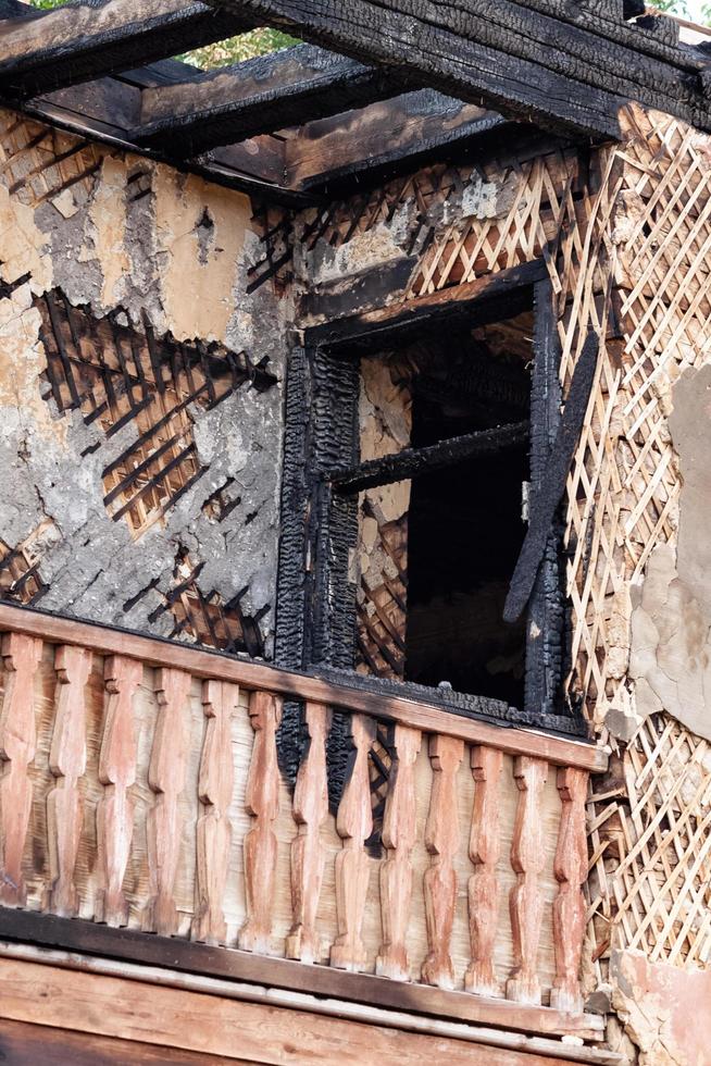 Abandoned burnt wooden slums after a fire. photo