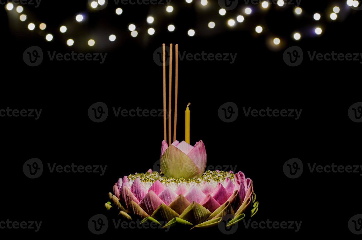 Selective focus on Lotus flower of pink lotus petal krathong on night background with bokeh light for Thailand full moon or Loy krathong festival. photo