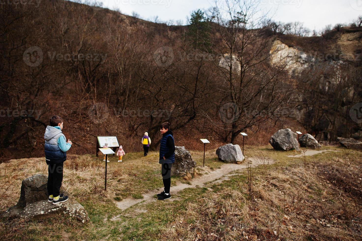 Family at Turold science trail, Mikulov, Czech Republic learn types of rock breeds. photo