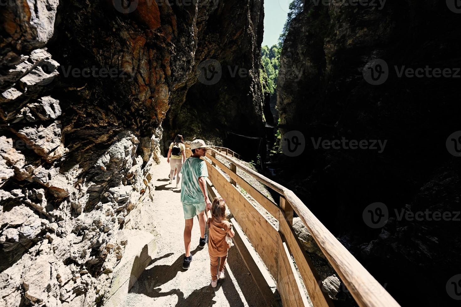 Brother with sister hikking in Liechtensteinklamm or Liechtenstein Gorge, Austria. photo