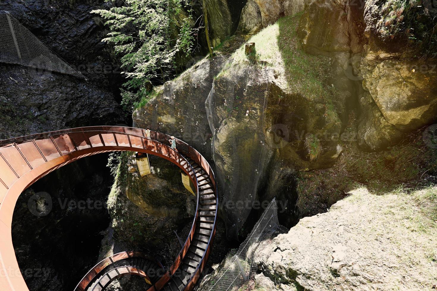 Mother with children walking in metal stairs in Liechtensteinklamm or Liechtenstein Gorge, Austria. photo