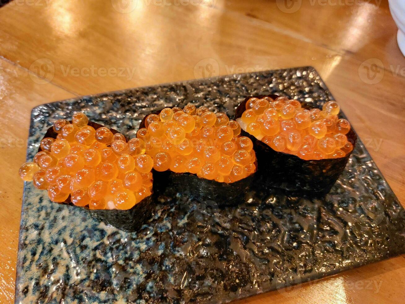 Japanese food called Ikura Onigiri, salmon roe roll wrapped in seaweed. photo