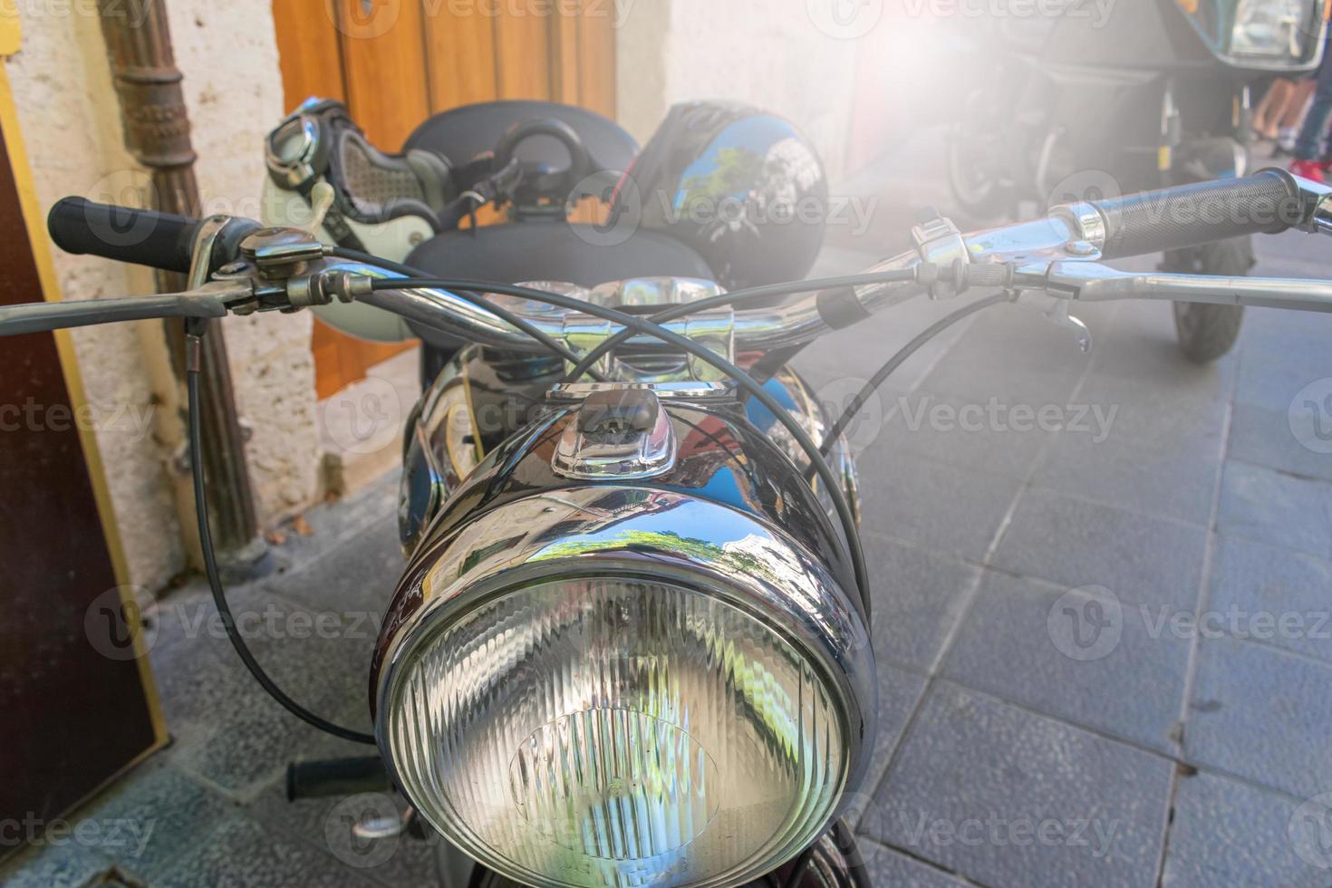 detail of the headlamp of a classic motorcycle photo