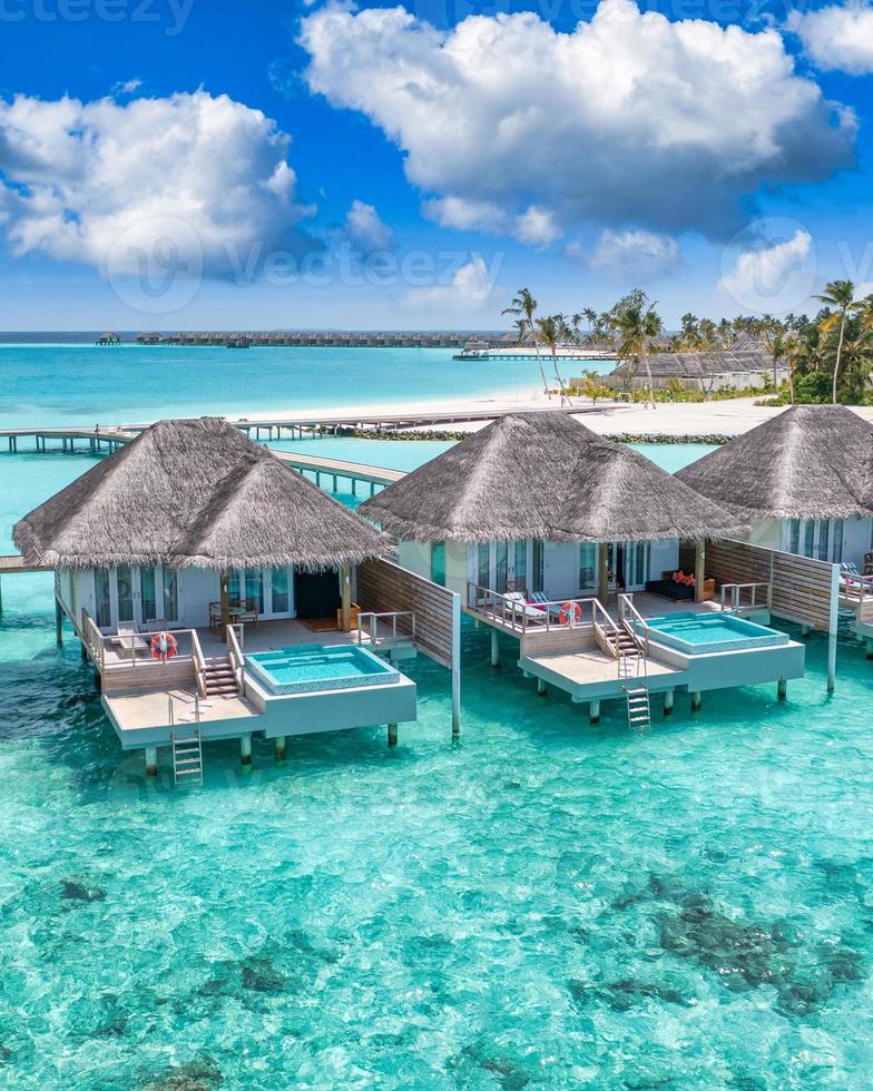 Maldives paradise island. Tropical aerial landscape, seascape with pier, water bungalows villas with amazing sea lagoon beach. Exotic tourism destination, summer vacation background. Aerial travel photo