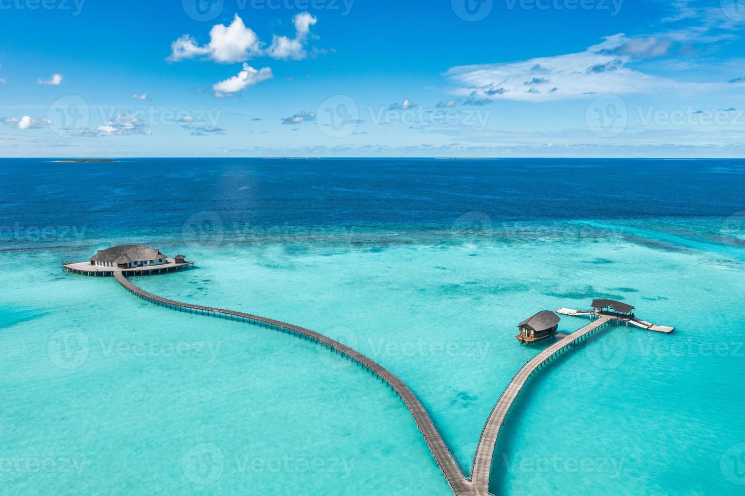 Maldives paradise island. Tropical aerial landscape, seascape pier pathway, water bungalows villas with amazing sea lagoon beach. Exotic tourism destination, summer vacation background. Aerial travel photo