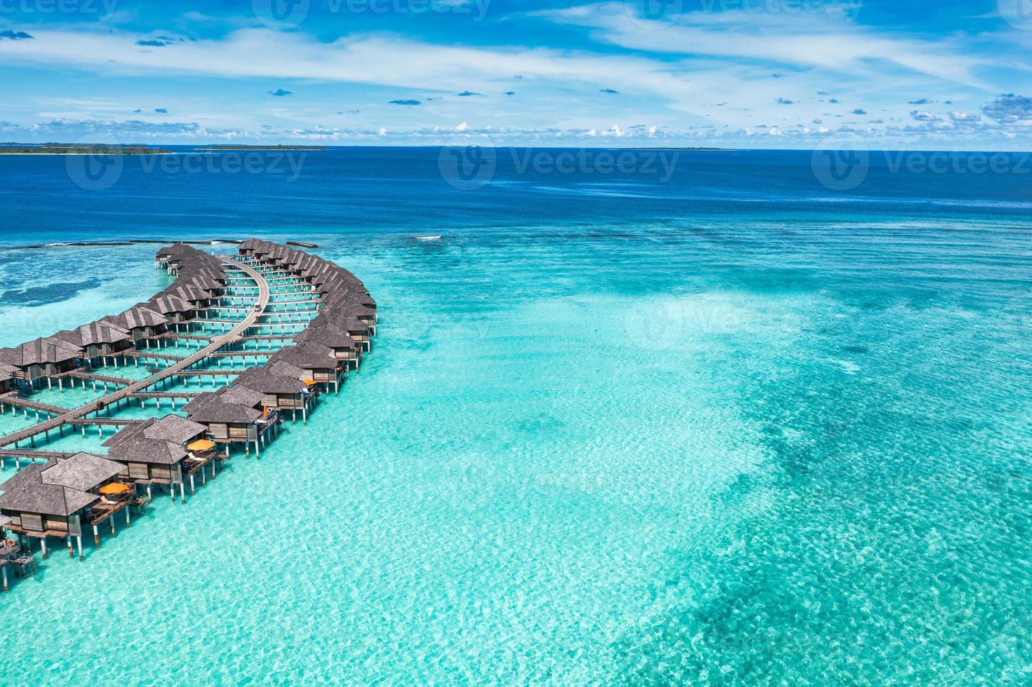 Maldives paradise island. Tropical aerial landscape, seascape pier pathway, water bungalows villas with amazing sea lagoon beach. Exotic tourism destination, summer vacation background. Aerial travel photo