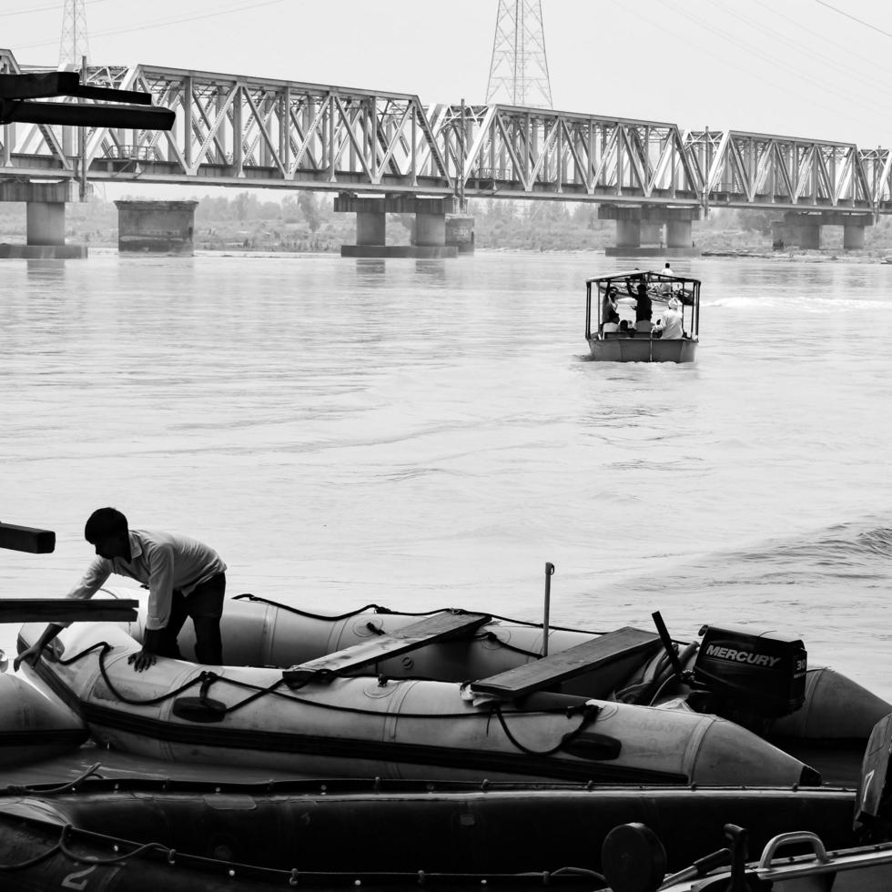 Garh Mukteshwar, UP, India, June 11 2022 -People are taking holy dip on the occasion of Nirjala Ekadashi, A view of Garh Ganga Brij ghat which is very famous religious place for Hindus-Black and White photo