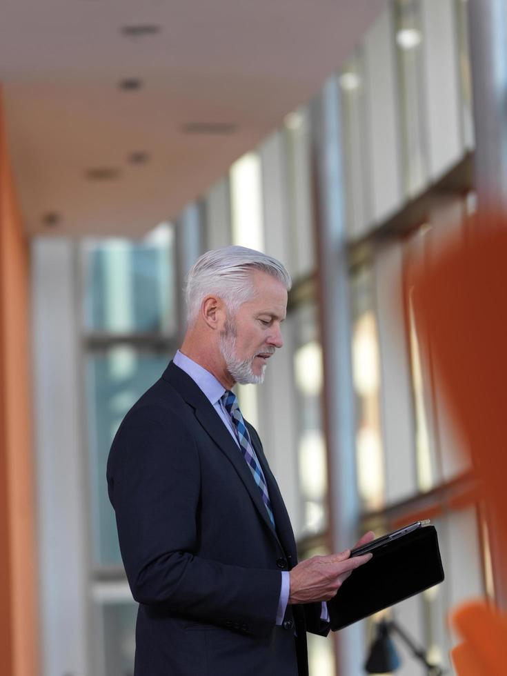 senior business man working on tablet computer photo