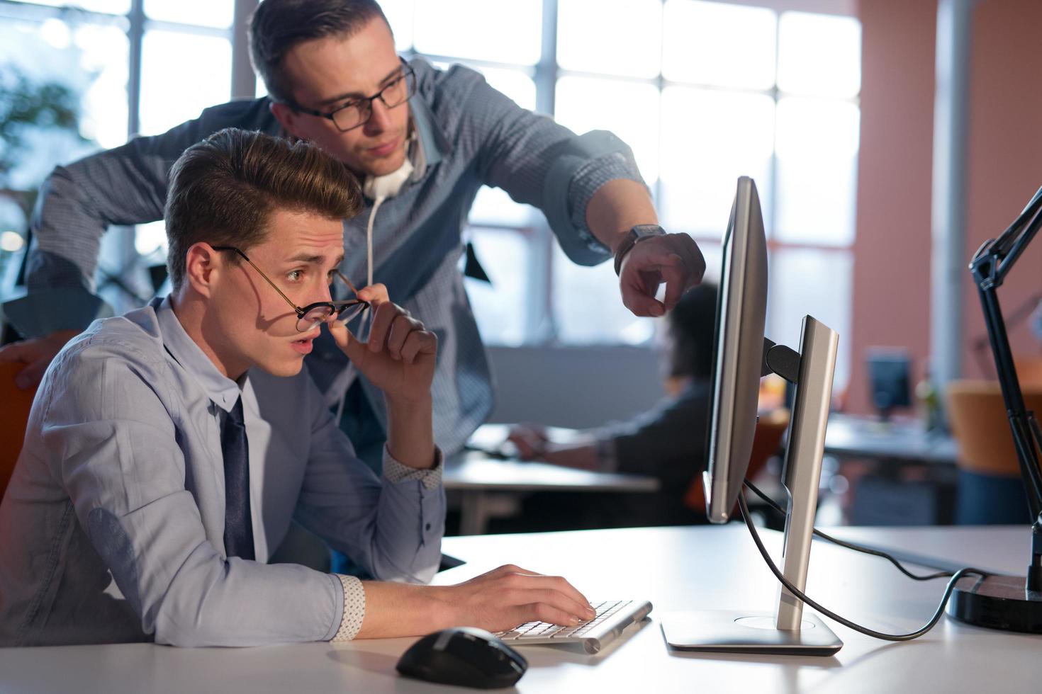 Two Business People Working With computer in office photo