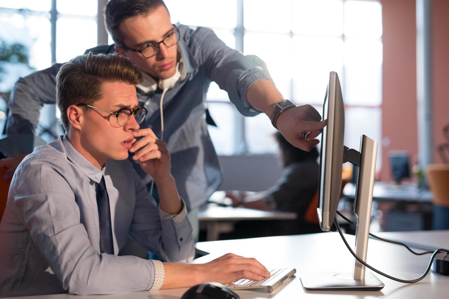 Two Business People Working With computer in office photo