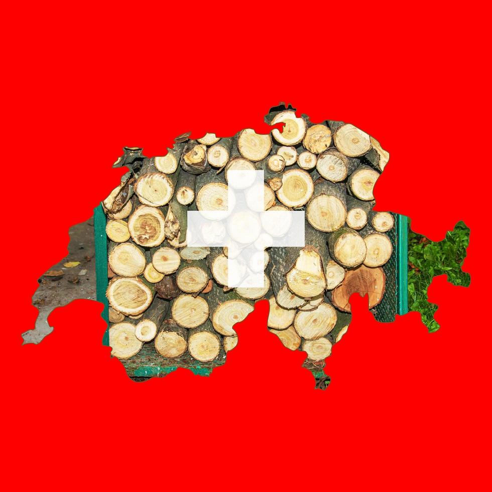 Outline map of Switzerland flag with the image of the national flag. Firewood inside the map. Collage illustration. Energy crisis. photo