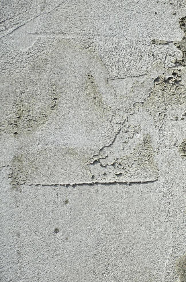 The texture of the wall, covered with gray foam polystyrene plates, which are smeared with a reinforcing mixture. Stage of wall insulation photo