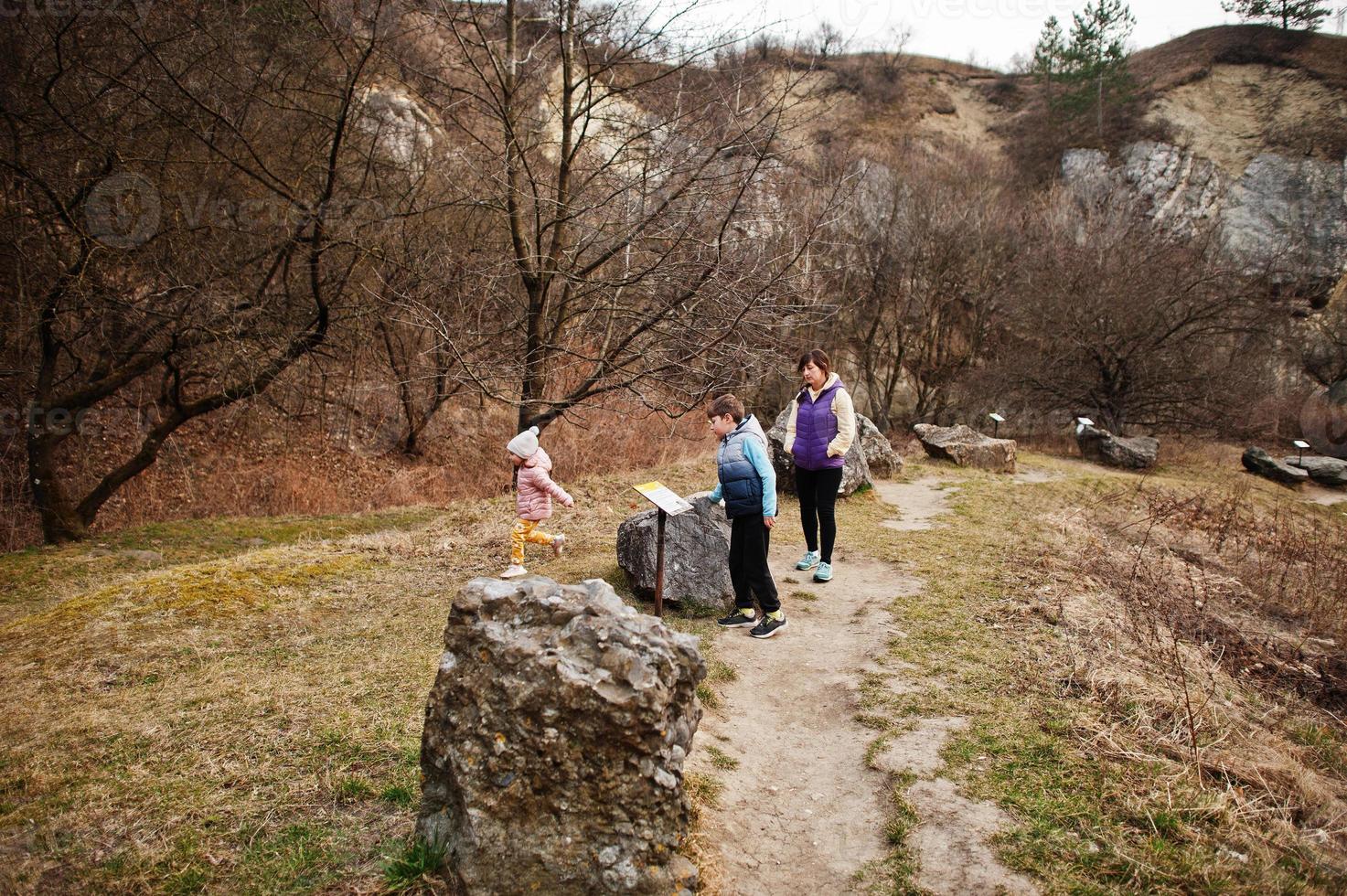 Family at Turold science trail, Mikulov, Czech Republic learn types of rock breeds. photo