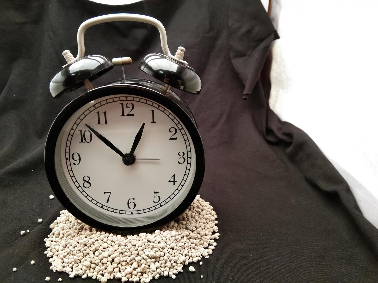 classic black alarm clock on black background photo