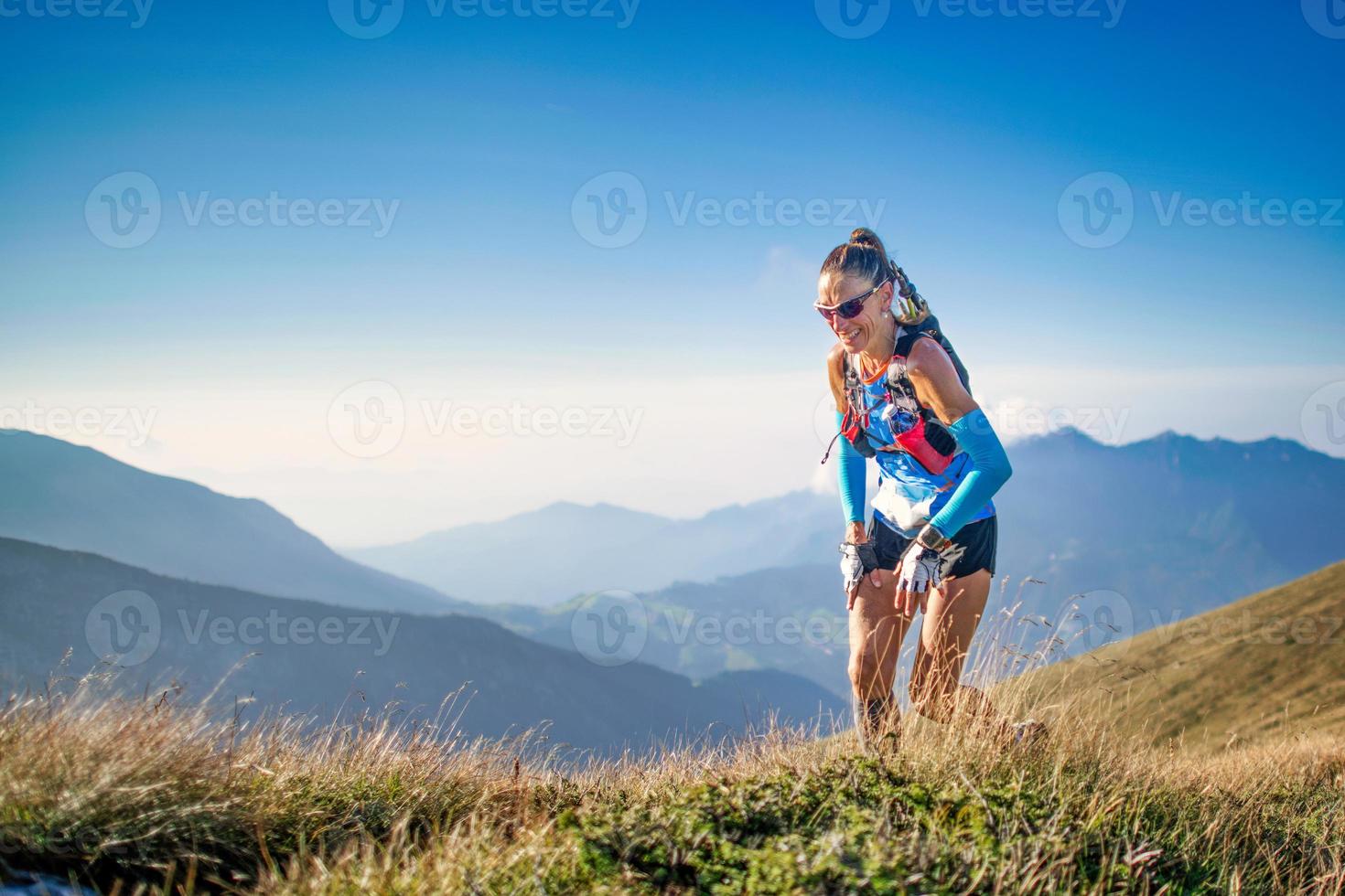 Sporty woman during a mountain trail ride photo