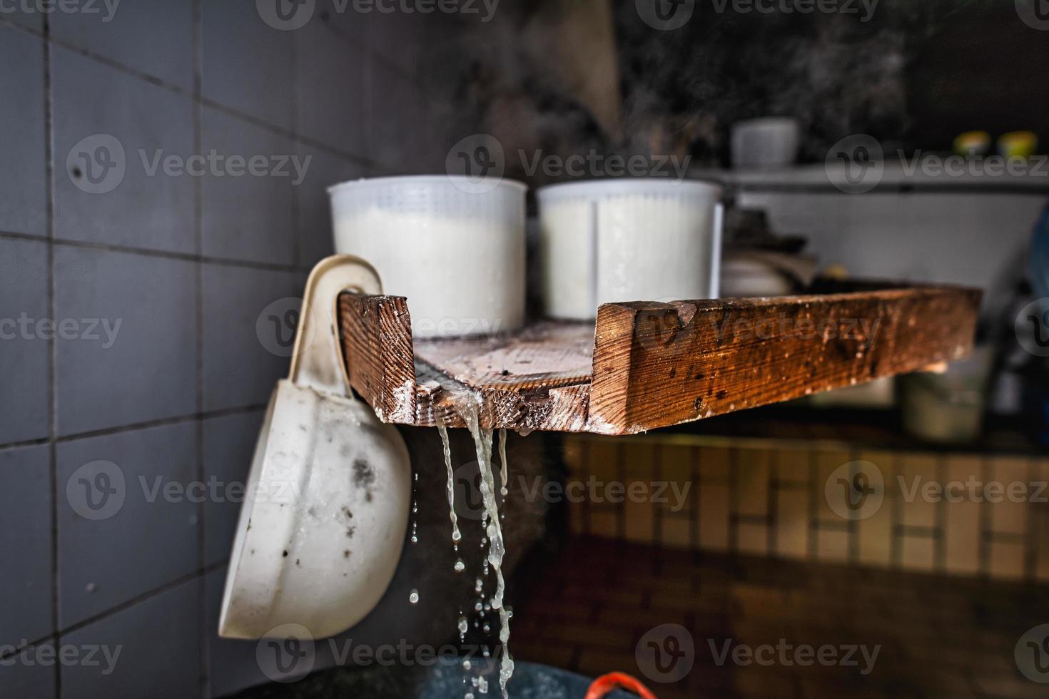 Interior of alpine hut with containers of genuine ricotta cheese photo