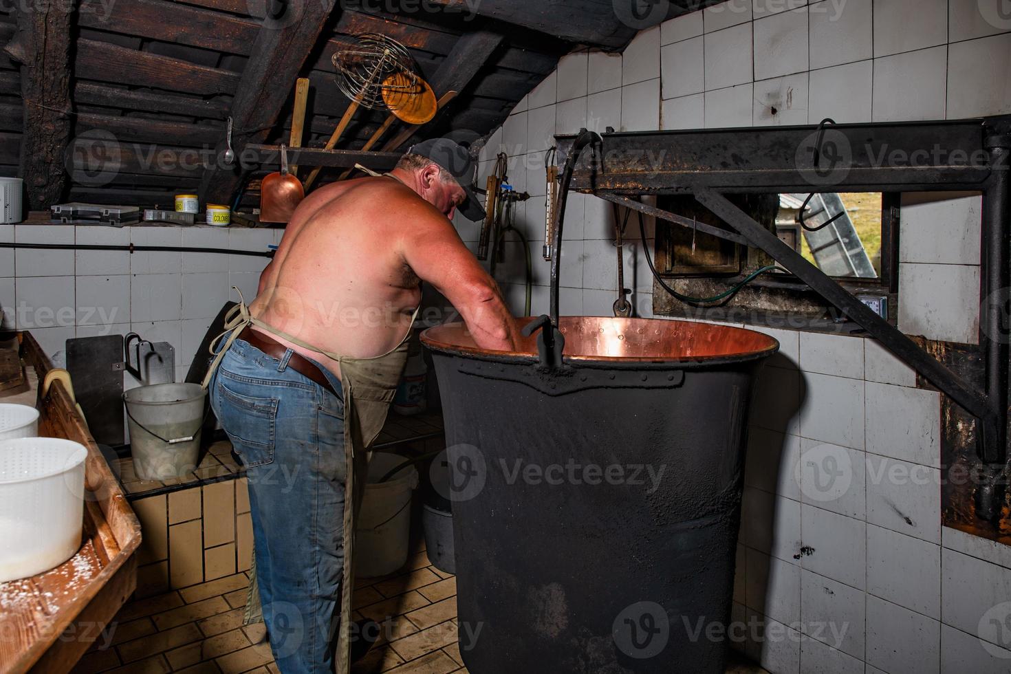 Inside a typical alpine hut in northern Italy the preparation of cheese photo