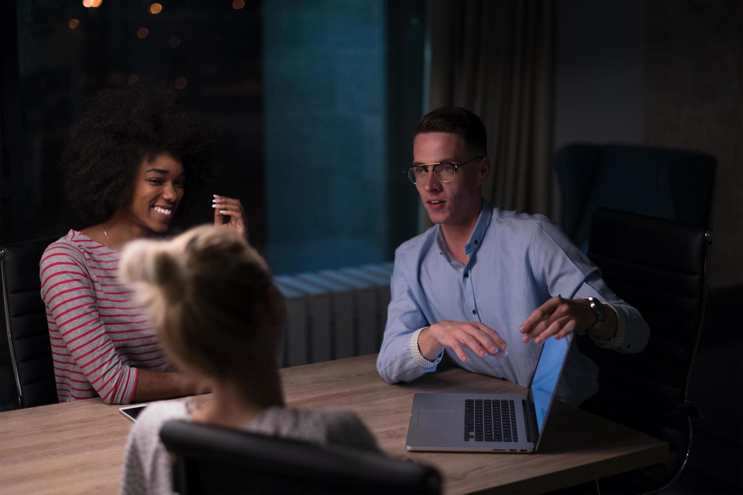Multiethnic startup business team in night office photo