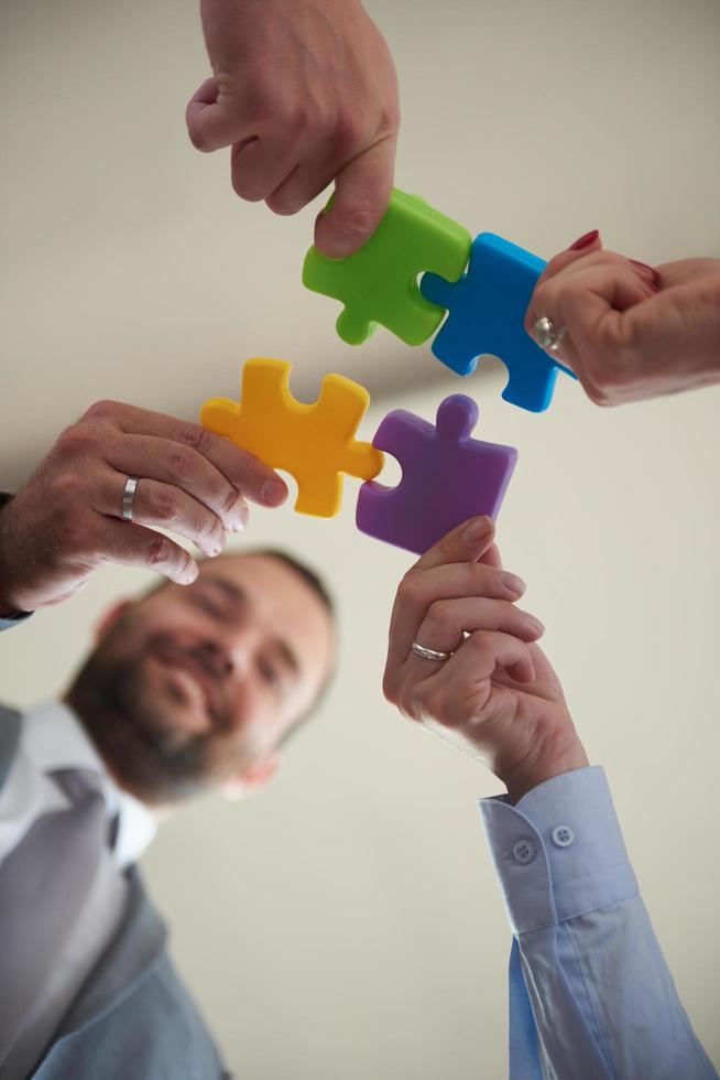 business people group assembling jigsaw puzzle photo