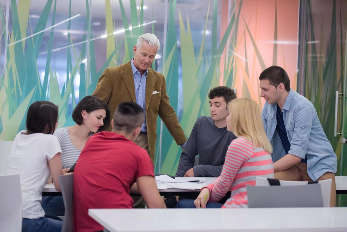 teacher with a group of students in classroom photo