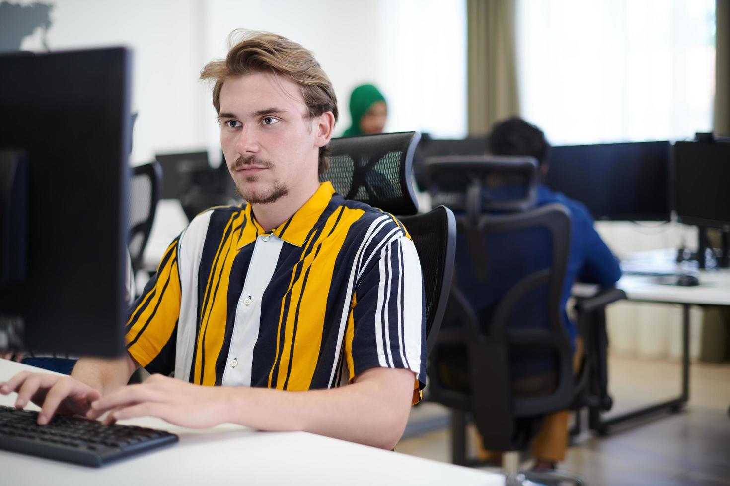 casual business man working on desktop computer photo