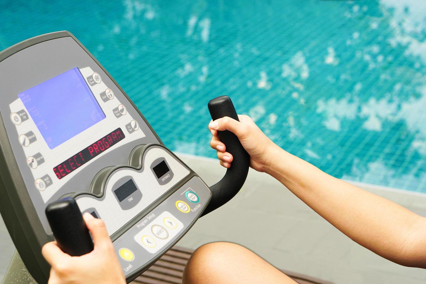 Close up of hand holding a electric bike exercise machine in fitness. photo