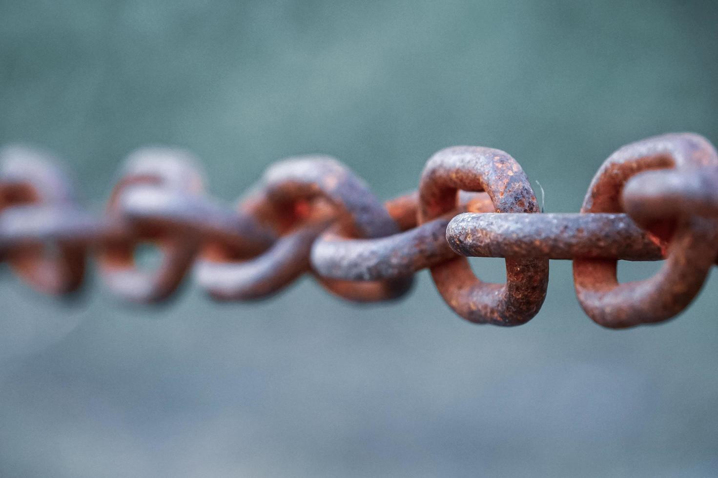 fence with an old rusty chain photo