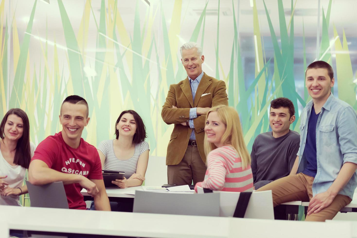 portrait of  teacher with students group in background photo