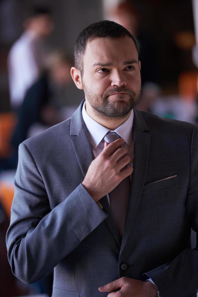 young business man portrait  at modern office photo