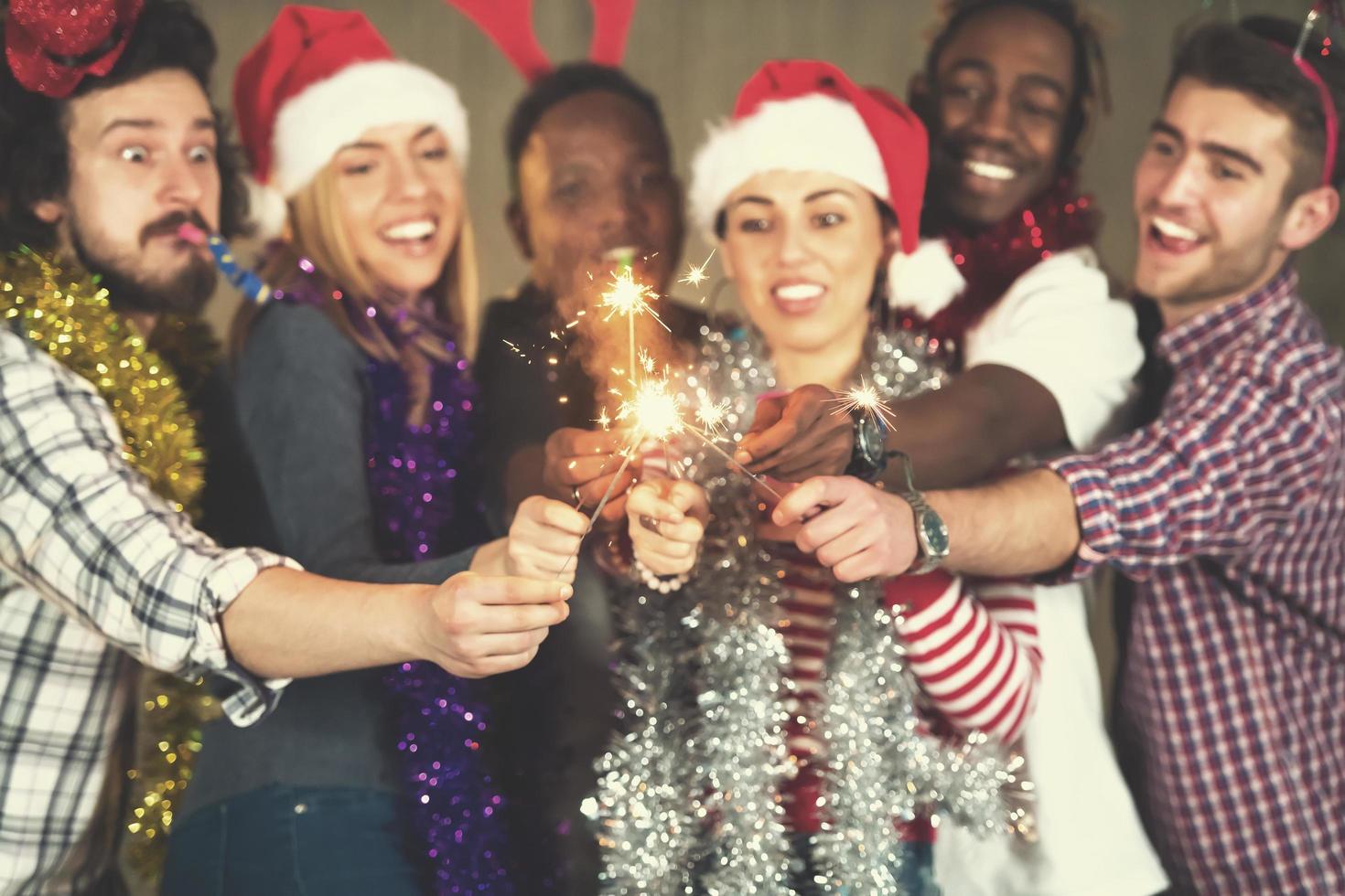 multiethnic group of casual business people lighting a sparkler photo