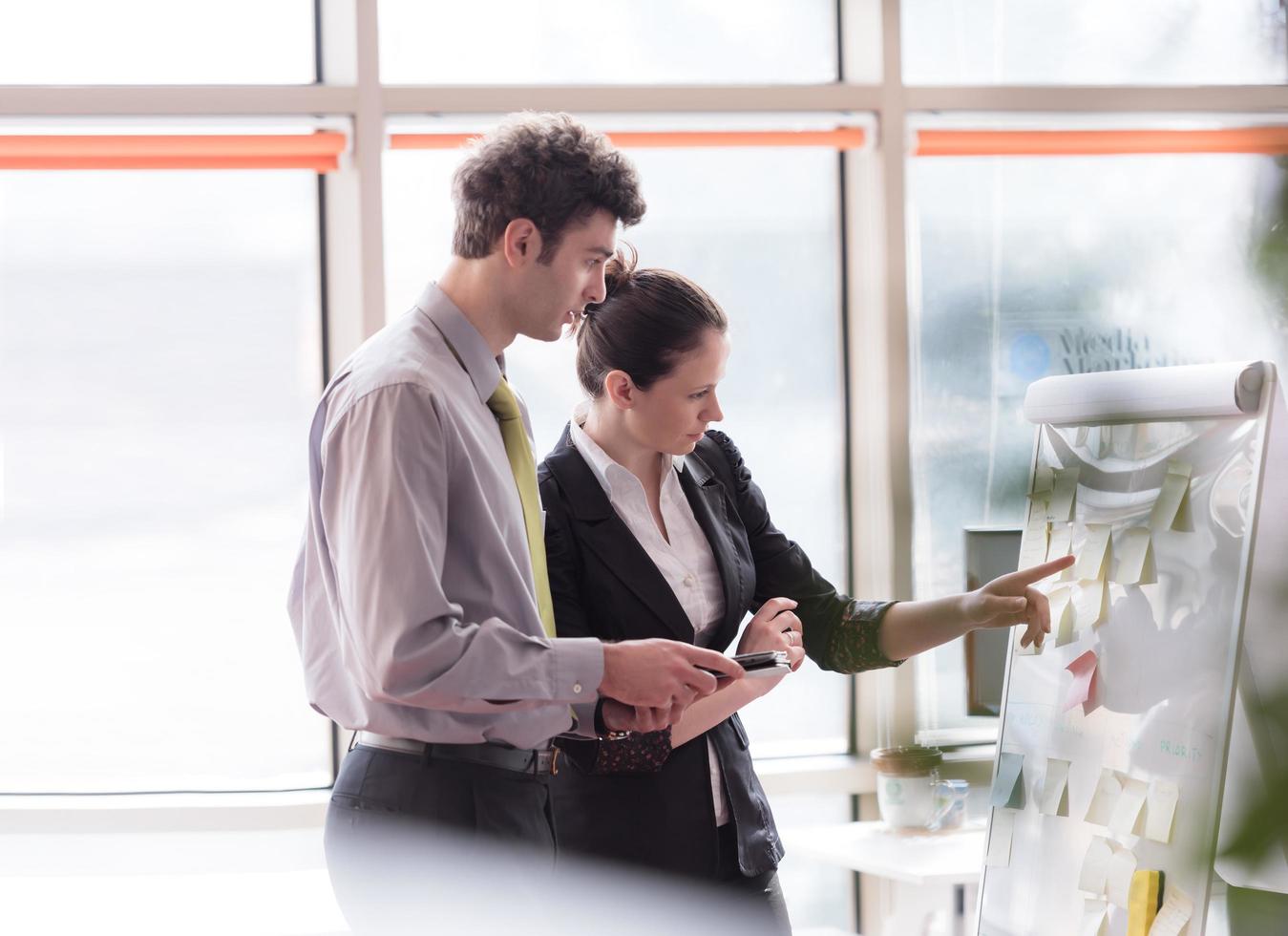 young couple working on flip board at office photo